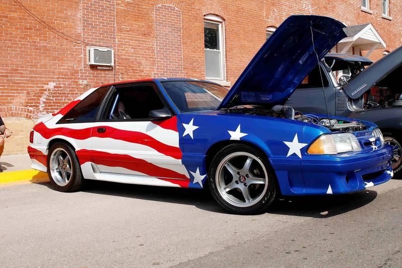 Marcus Brand of Port Byron brought his stand out 1991 stars and stripes Ford Mustang to the Erie Car Show on Saturday.