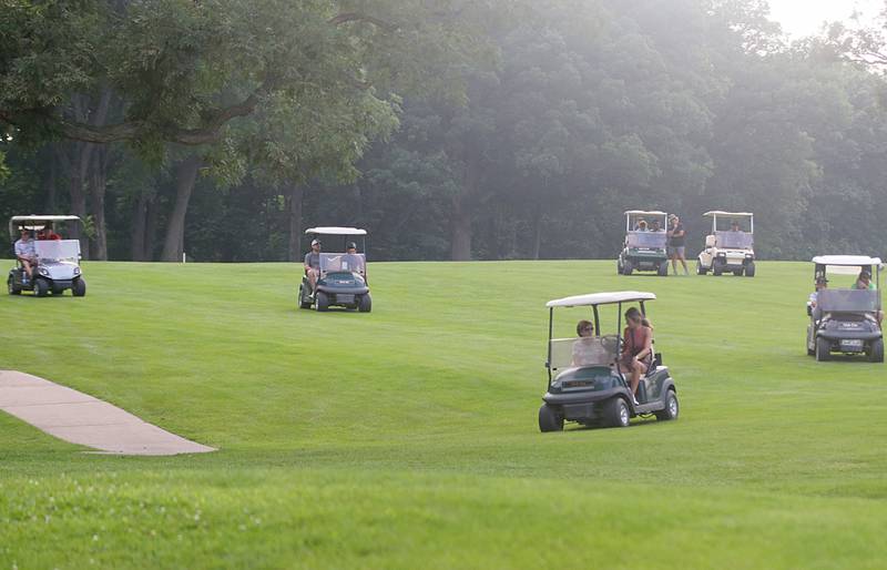 Spectators watch the final foursome on the 18th hole during the 2022 Richard J. Berry Memorial golf tournament at the Eastwood in Streator.