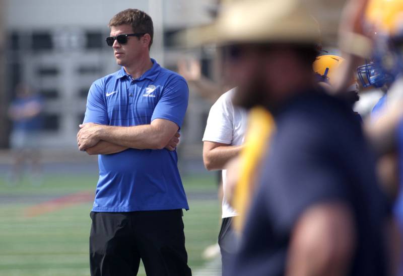 Lyons Township Head Coach Jon Beutjer watches his players during a 7-on-7 football tournament game against Maine South at West Aurora High School on Friday, June 23, 2023.
