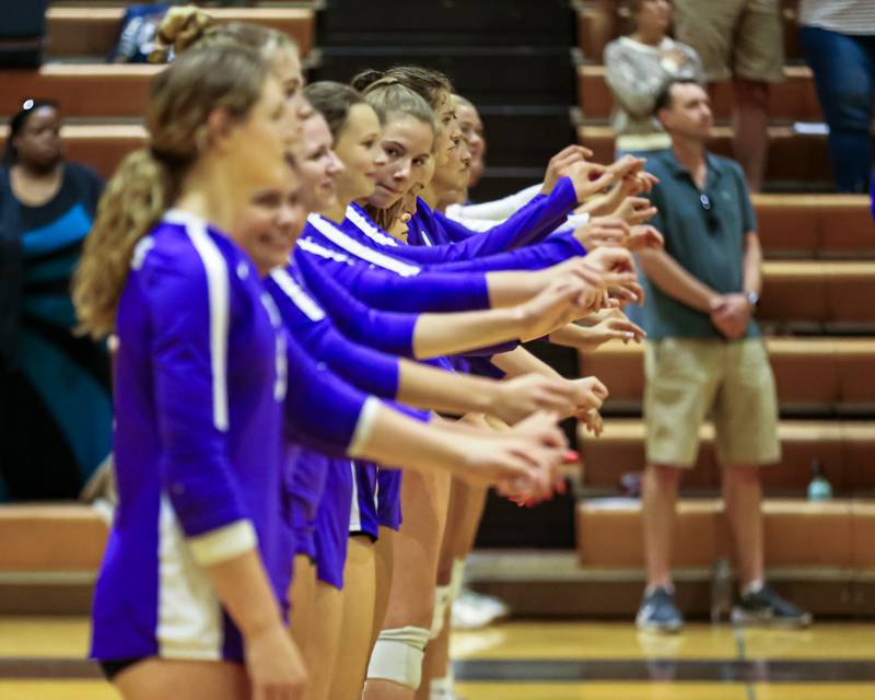 Downers Grove North stands for the playing of the National Anthem before their match at Downers Grove South.  Sept 7, 2023.