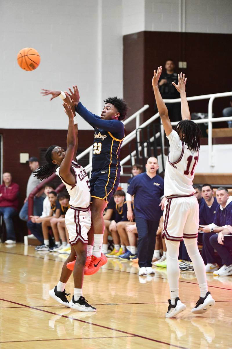 Sterling's Kaedon Phillips passes away from pressure by Kankakee's Cedric Terrell III, left, and Jordan Davis during the Kays' 85-50 victory over Sterling in the IHSA Class 3A Morris Regional championship on Friday, Feb. 28.