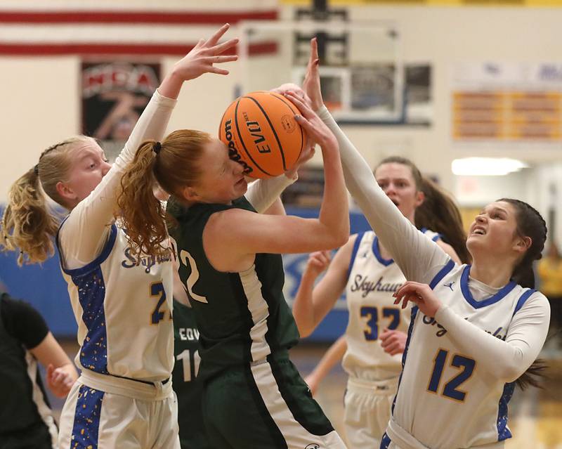 St. Edward's Layne Dawson (center) battles for a rebound between Johnsburg's Carlie Majercik (left) and Addie Graff (right) during the IHSA Class 2A Johnsburg Sectional girls basketball championship game on Thursday, February, 26, 2026, at Johnsburg High School.