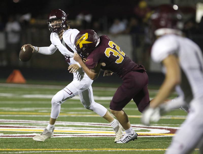 Marengo's Joshua Holst tries to get out of the grasp of Richmond-Burton’s Steven Siegel as he looks to pass the ball during a Kishwaukee River/Interstate 8 Conference football game Friday, Sept. 9, 2022, between Richmond-Burton and Marengo at Richmond-Burton Community High School.