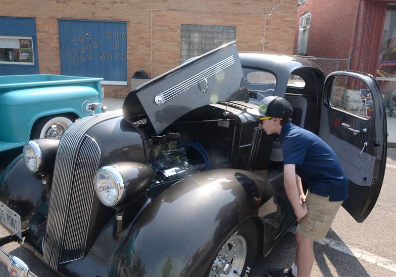 Trevor Knutti of Lanark checksout the 1935 Pontiac coupe owned by Mark Scarutino of Dixon at the Milledgeville car show on Sunday, June 4. Trevor was at the show helping show his grandpa's 1950 Ford 8N tractor.