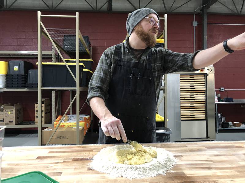 Mario Scordato, of Woodstock, asks Stephanie Scordato to check the pasta machine as he mixes a duck egg pasta he's experimenting with on Wednesday, March 6, 2024. The couple has ran PastaBar in McHenry for 10 months.
