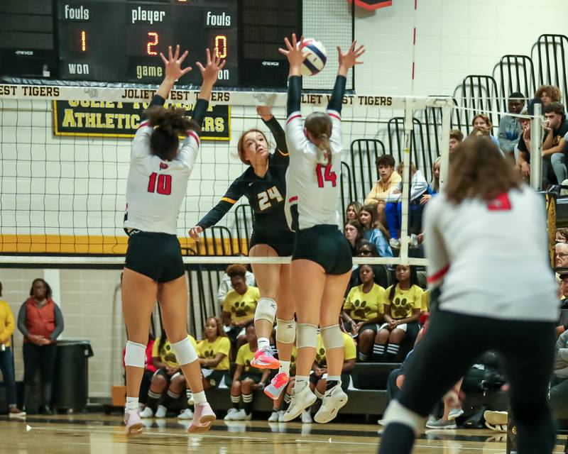 Joliet West's Natalia Harris (24) spikes the ball during regional final volleyball match between Bolingbrook at Joliet West.  Oct 26, 2023.