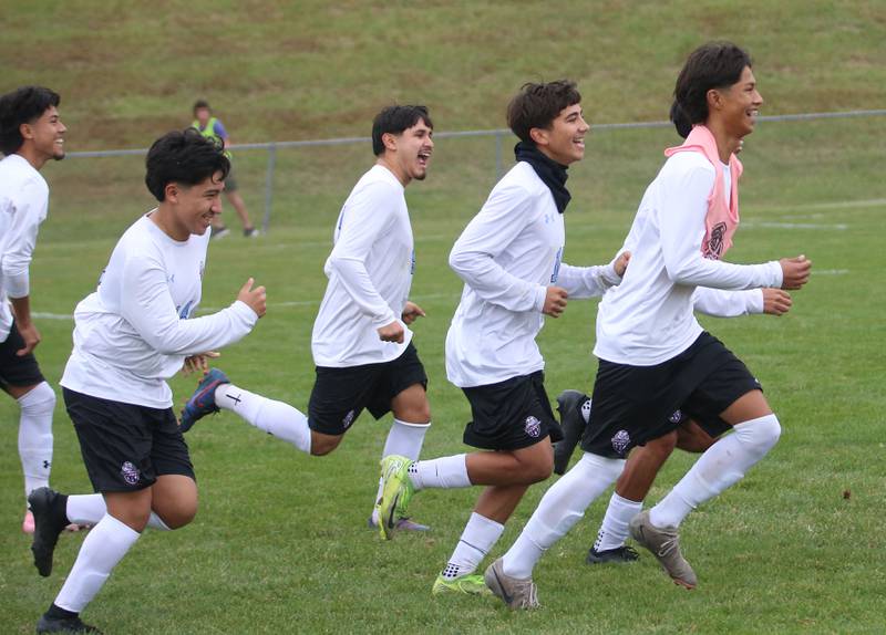 Members of the Kankakee soccer team run onto the field after celebrating a victory against L-P during the Class 2A Regional title game on Saturday, Oct. 25, 2025 at Ottawa High School.