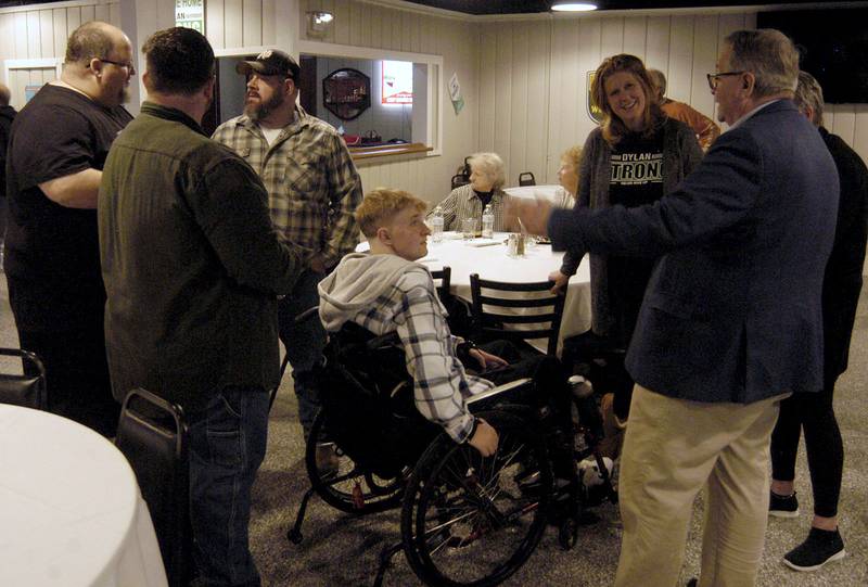 Visitors gather around Dylan Wescott during a Welcome Home Party at Emerson's Pub in Rock Falls on Saturday, Nov. 22.