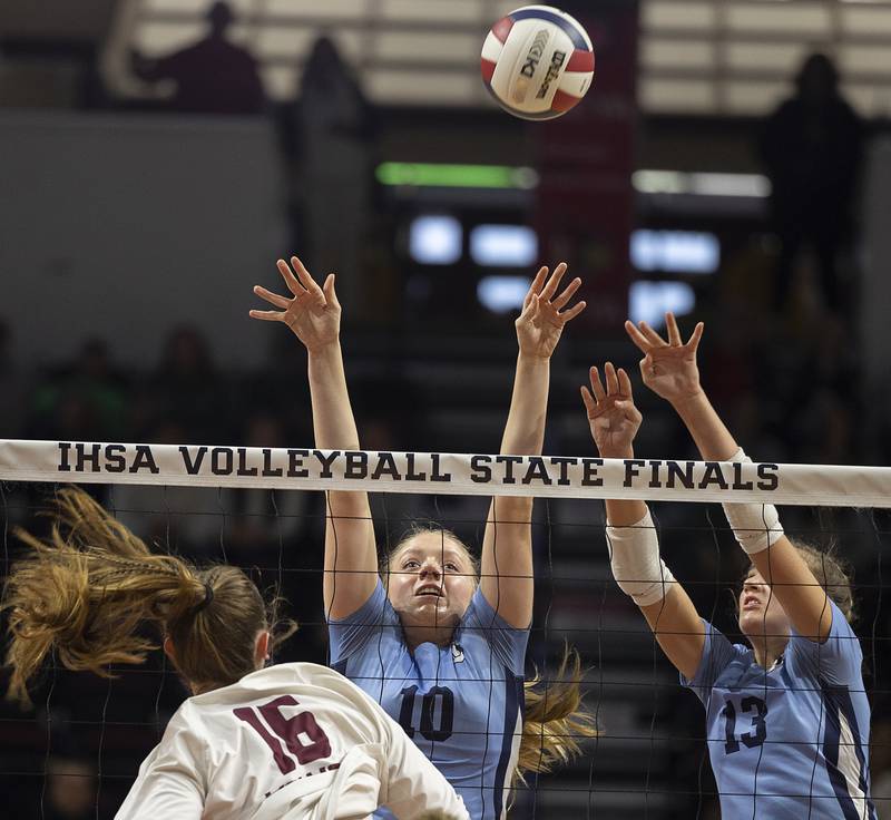 DePaul College Prep's Layla Christian (left), and Kalia Kroth go up for a block against Prairie Ridge's Adeline Grider Saturday, Nov. 16, 2024, in the Class 3A third place state volleyball match at CEFCU Arena in Normal.