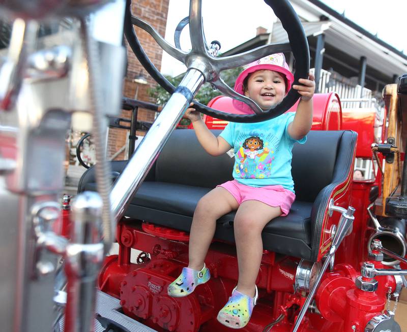 Sofia Camargo, 2, of Wauconda sits in "Old Betsy," a 1931 Pirsch fire engine, owned by the Wauconda Fire Department, during National Night Out on Main Street on Tuesday, August 1st in Wauconda.  
Photo by Candace H. Johnson for Shaw Local News Network.
