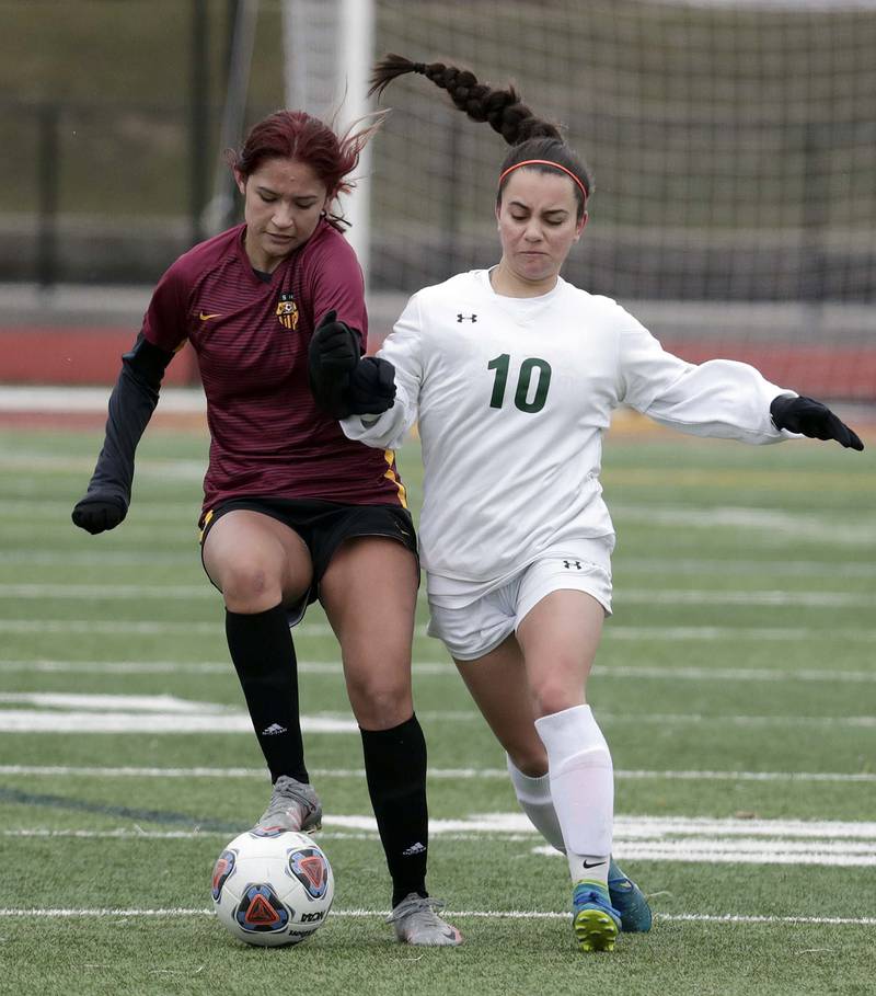 Schaumburg's Emily Carlos, left, battles Crystal Lake South's Bella Farrington during girls soccer action Saturday, March 26, 2022 in Schaumburg.