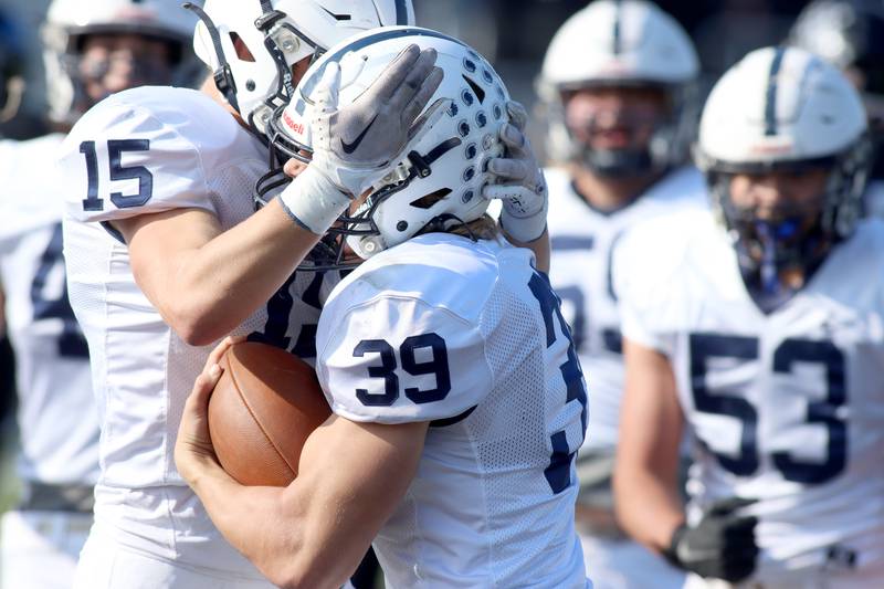 Cary-Grove’s Holden Boone (39) is greeted after scoring a touchdown against Highland Park in second-round IHSA Class 6A playoff action at Wolters Field in Highland Park Saturday.