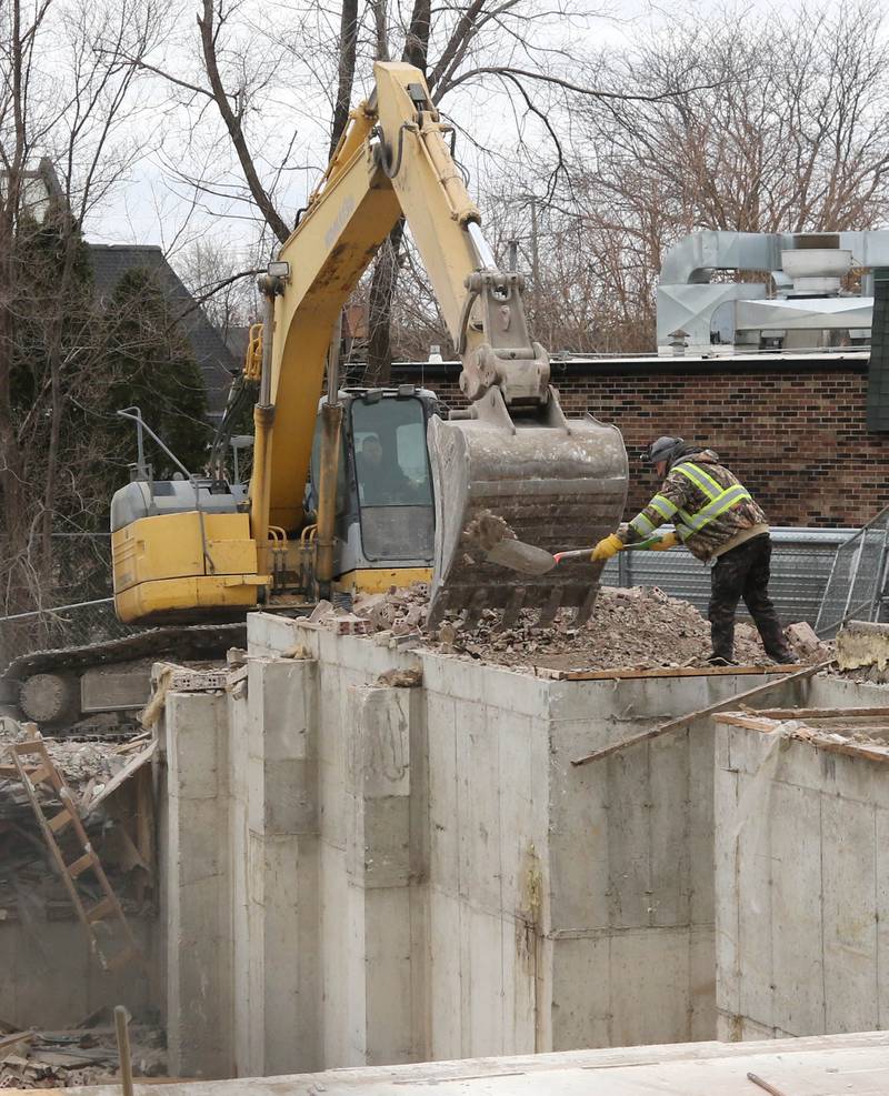 Crews shovel debris Thursday, Jan. 16, 2025, at 1024 W. Hillcrest Drive in DeKalb where an apartment building was torn down. The structure was ravaged by fire on Dec. 22, 2024, and condemned.