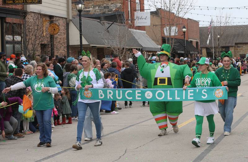 Employees with Bruce and Ollie's walk along Mill Street during the St. Patrick's Day parade on Saturday, March 15, 2025 downtown Utica.