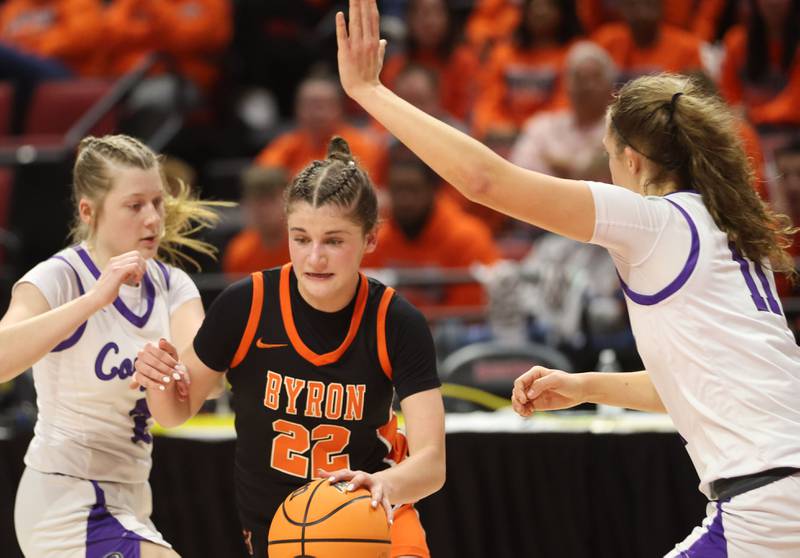 Byron's Aubrey Fuller dribbles between Breese Central players Mallory Shubert and Taylor Trame during the Class 2A title game on Saturday, March 7, 2026 at CEFCU Arena in Normal.