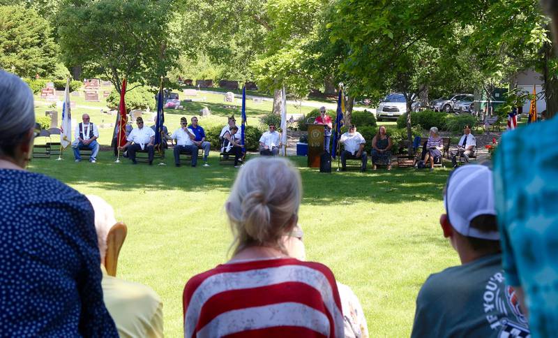 Karen Howard reads the names of local military veterans buried in Elburn cemeteries on Monday, May 29, 2023 at Blackberry Township Cemetery in Elburn.