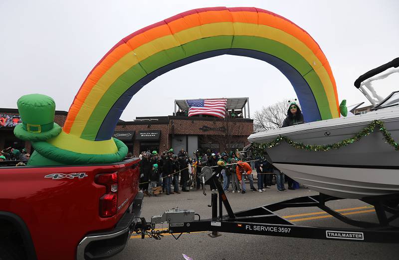 A dog is walked as the McHenry ShamROCKS the Fox Festival Parade makes its way along Green Street on Saturday, March 14, 2026. In McHenry.