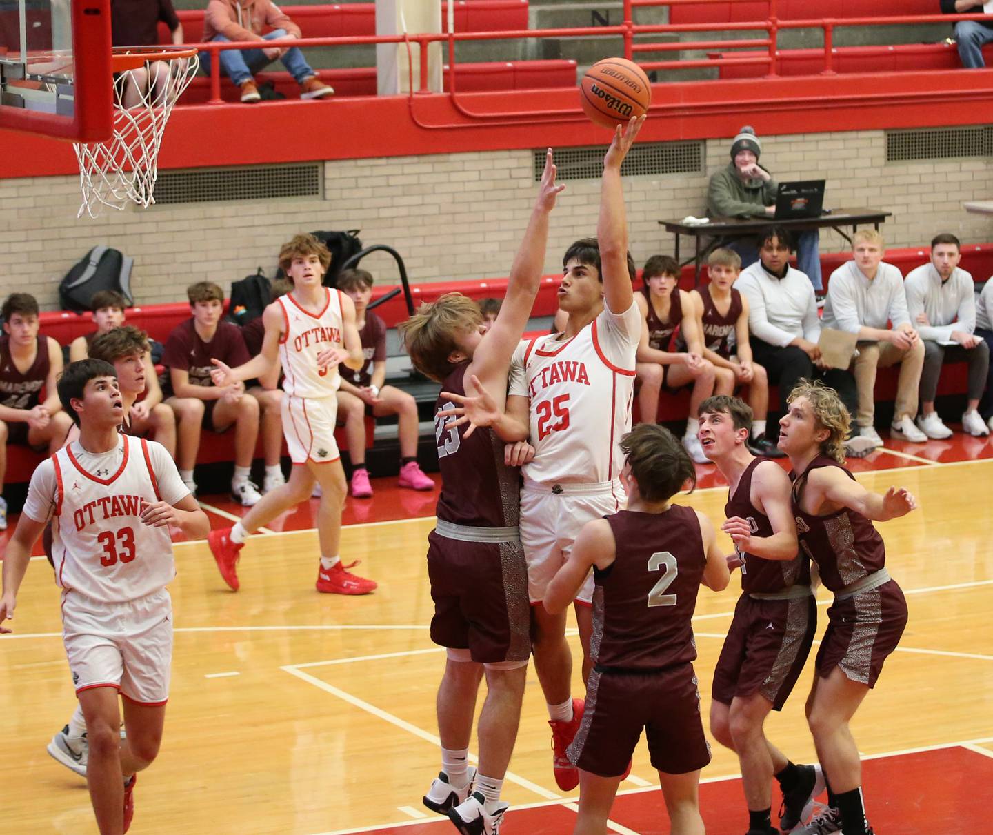 Ottawa’s Payton Knoll (25) gets a shot off in the lane as he is guarded by Marengo defenders during the Dean Riley Shootin’ The Rock Tournament on Monday, Nov. 21, 2022 at Kingman Gymnasium.