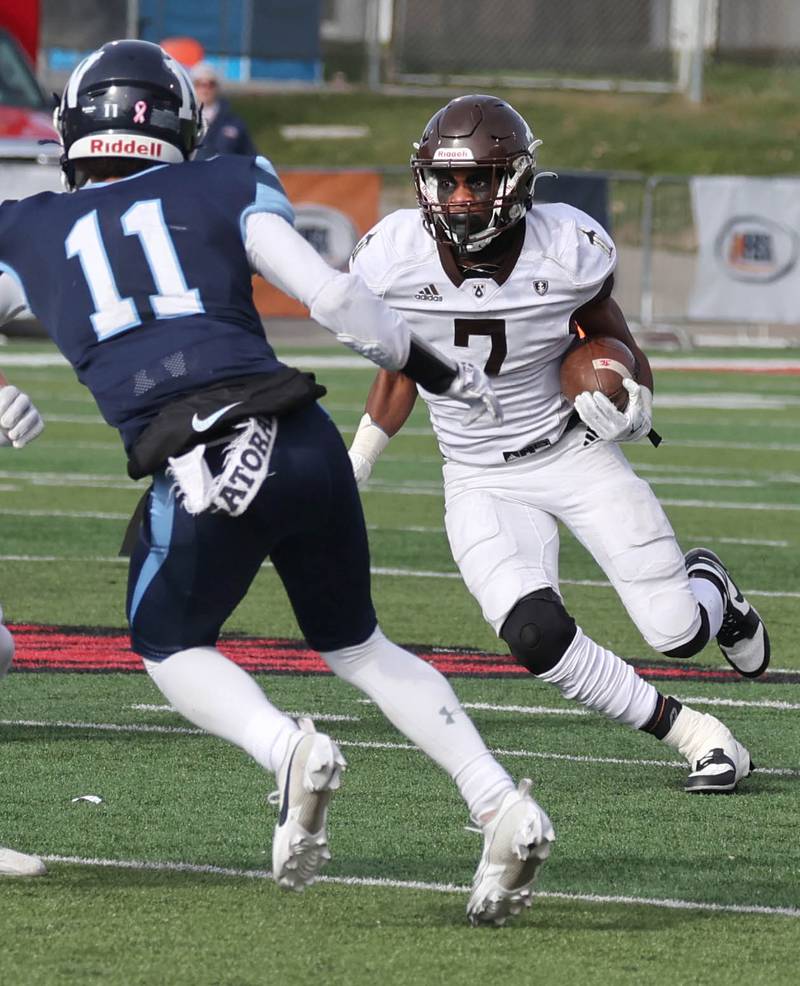 Joliet Catholic's HJ Grigsby tries to get by Nazareth's James Penley Saturday, Nov. 25, 2023, during their IHSA Class 5A state championship game in Hancock Stadium at Illinois State University in Normal.