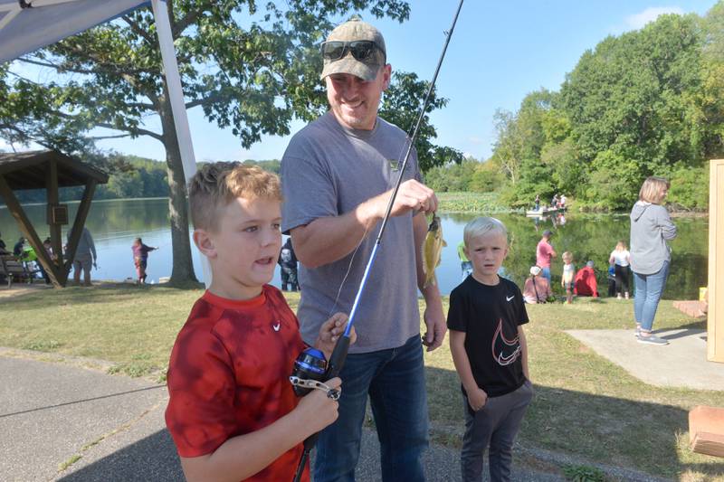 Collin Wiersema, 8, of Morrison, and his dad, Ryan, turn in the bluegill Collin caught at the Whiteside County Sheriff Office and Mounted Patrol's annual fishing derby at Morrison-Rockwood State Park in Morrison on Saturday, Sept. 9, 2023.