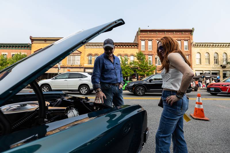 Lockport Mayor Steven Streit and Wendy Streit admire a 1965 Oldsmobile 442 during Cruisin' Into Lockport on June 2, 2025.