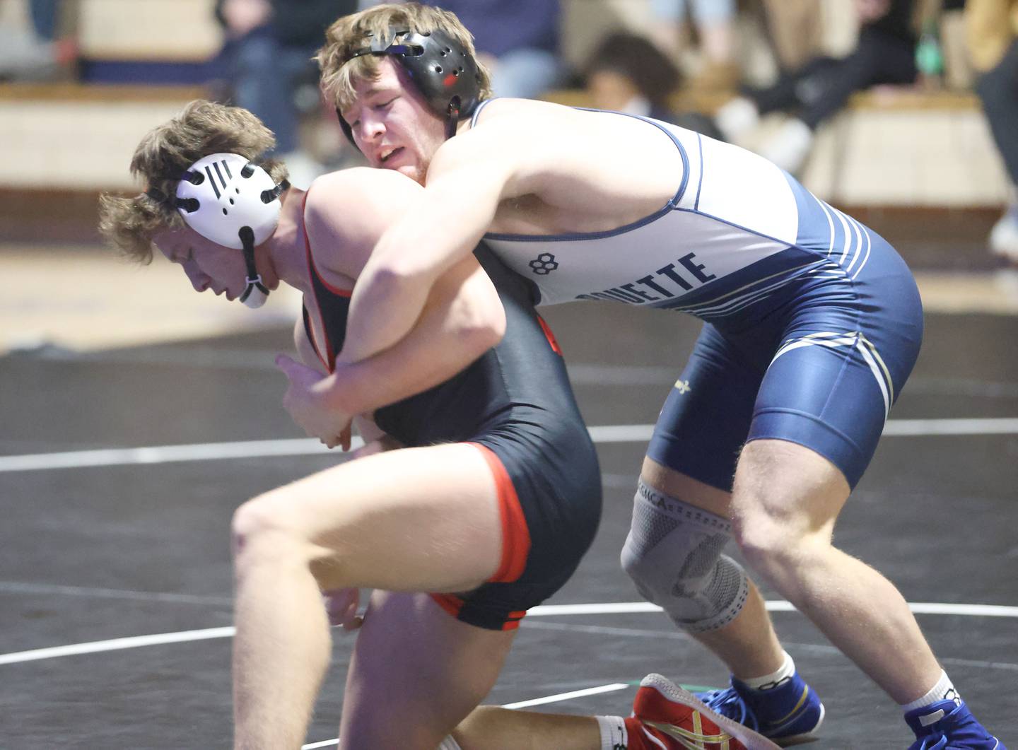 Marquette's Riley Leifheit wrestles Bradley-Bourbonnias's Kayden Roach on Wednesday, Jan. 14, 2026 in Bader Gymnasium at Marquette Academy.