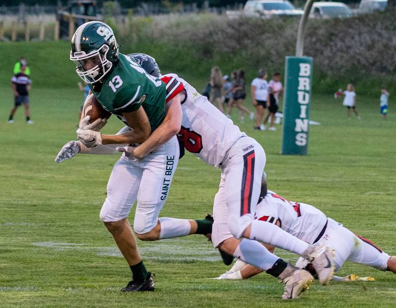 St. Bede's Ben Wallace (13) tries to break a tackle Friday, Sept. 2, 2022 in Peru.