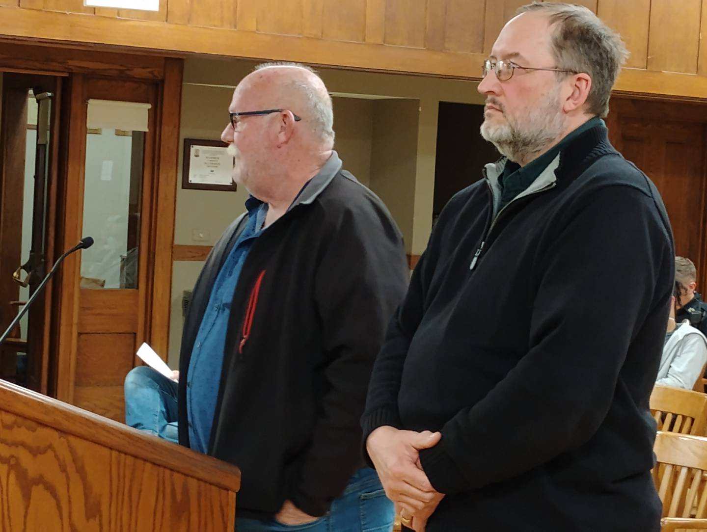 Geneva Construction Company Vice President Cass Price, left, and Geneva Public Works Director, listen to concerns from 3rd Ward Alderperson Dean Kilburg about subcontractors' public urination in front of his house last summer. Price said he didn't get the Porta-Potty out there in time, but he would have them out on time for this year's street improvement work.