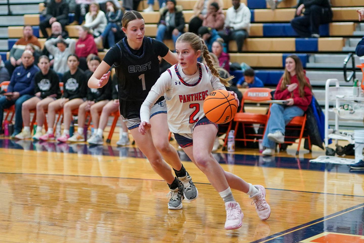 Oswego’s Ashley Cook (2) drives the baseline against Oswego East's Aubrey Lamberti (1) during a basketball game at Oswego High School on Wednesday, January 22, 2025.