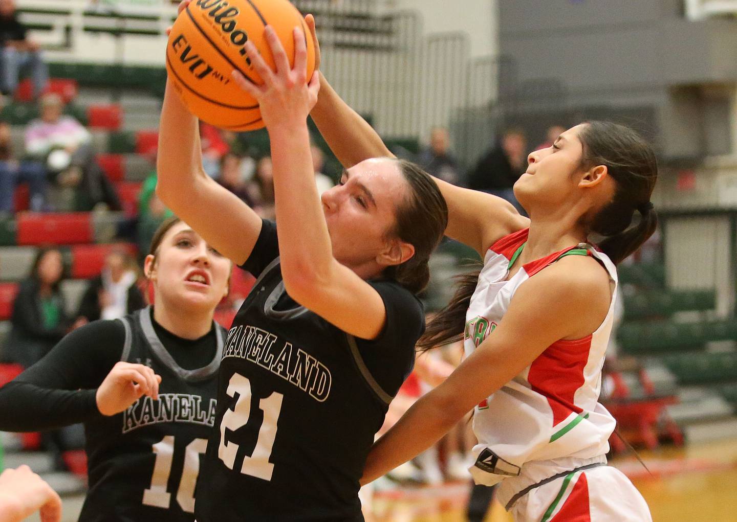 Kaneland's Kyra Lilly grabs a rebound over L-P's Nathali Aguirre on Wednesday, Jan. 15, 2025 in Sellett Gymnasium at L-P High School.