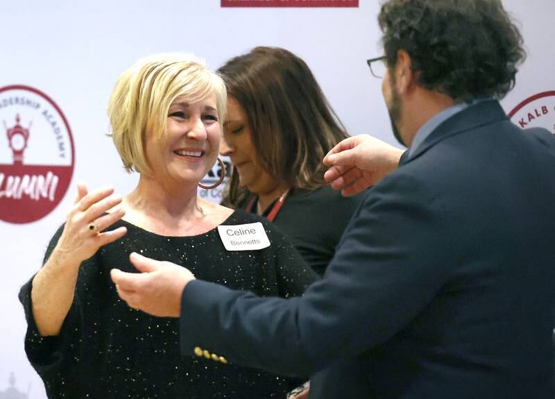 This years Ambassador of the Year award winner Celine Bennetts is congratulated by last years winner Gavin Wilson after receiving her award Thursday, Feb. 9, 2023, during the DeKalb Chamber of Commerce’s Annual Celebration Dinner in the Barsema Alumni and Visitors Center at Northern Illinois University.