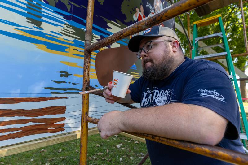 Joe Diaz of the Walldogs observes progress of the painting of the Streator mural on Thursday, Sept. 11, 2025 at City Park in Streator.