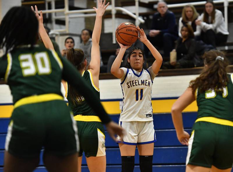 Joliet Central's Isabel Sanchez (11) shoots a 3 point shot during the SPC Conference game on Friday, Dec. 16, 2022, at Joliet.