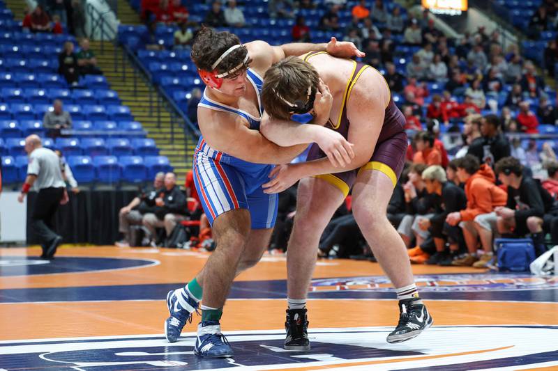 Marmion Academy's Joseph Favia, left, rushes Montini's Gavin Ericson in the 285-pound match during Marmion Academy's victory over Montini in the IHSA Class 3A Dual Team State championship on Saturday, Feb. 28, 2026.