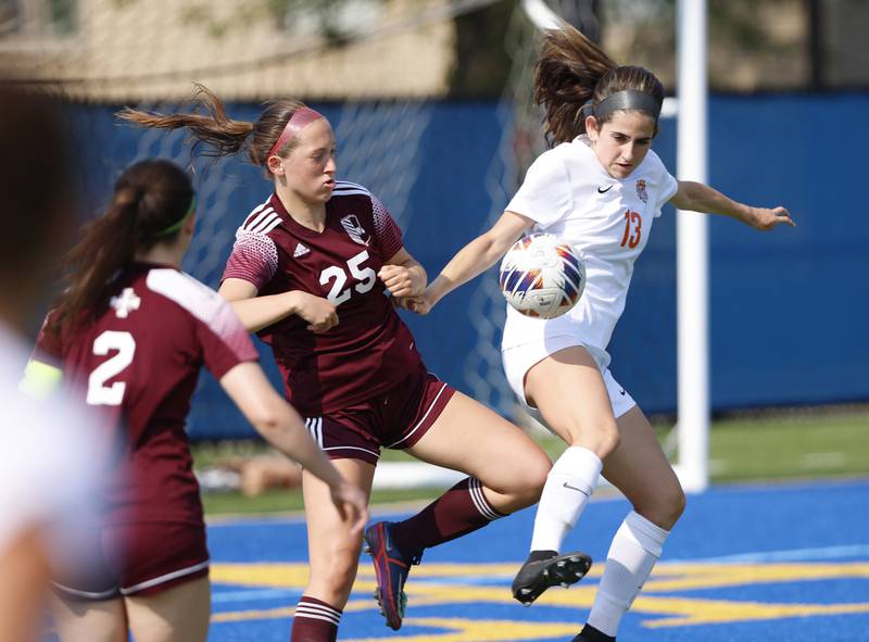 Crystal Lake Central's Jordin Gaunaurd (13) goes up against St. Ignatius' Maggie Helms (25) during the 2A girl's varsity supersectional soccer match between Crystal Lake South and St. Ignatius high schools on Tuesday, June 3, 2025 in Chicago.