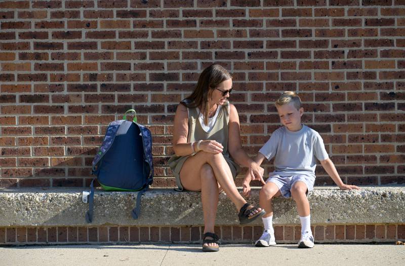 Rachel Busch talks with her 2nd grade son Kaden, 7 before the first day of classes at Louise White Elementary School in Batavia on Wednesday, Aug 14, 2025.