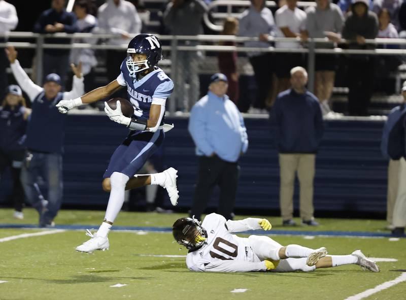 Nazareth's Trenton Walker (8) runs after making a reception during the varsity football game between Joliet Catholic and Nazareth academies on Friday, Sep. 27, 2024 in La Grange Park.