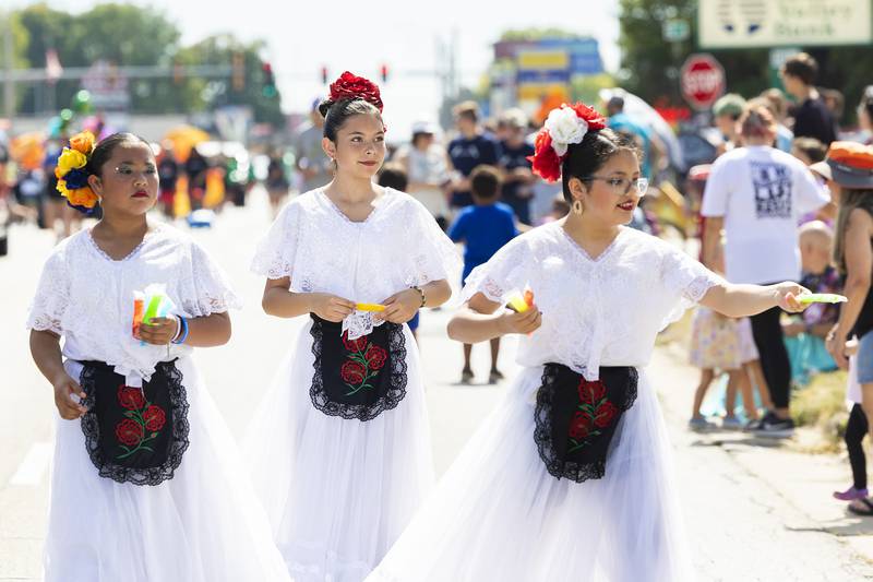 Dancers with Ballet Folklorico hand out treats Saturday, Sept. 14, 2024, during the Fiesta Days parade. After the parade the group put on a show of traditional Hispanic dancing.