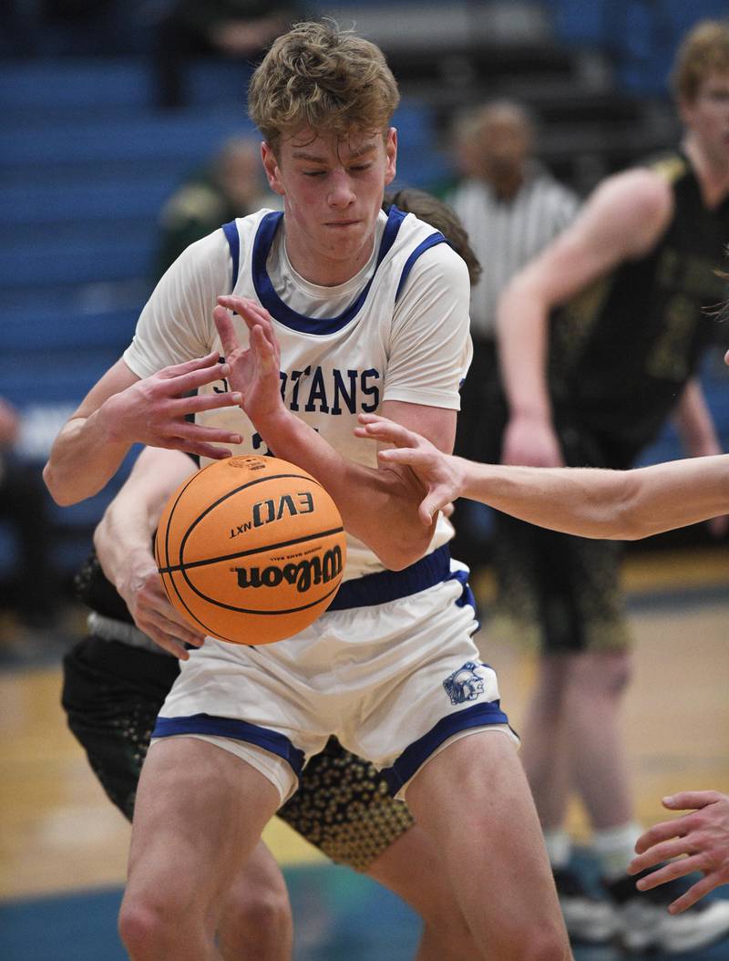 St. Francis’ Aaron Cook battles for a loose ball against St. Edward in a boys basketball game in Wheaton on Tuesday, December 6, 2022.