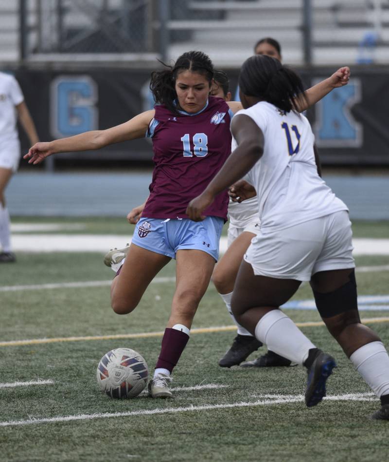 Kankakee's Alexsandra Quintanar takes a shot on goal as Crete-Monee's Jayda Owusu defends in a game on May 12, 2025.