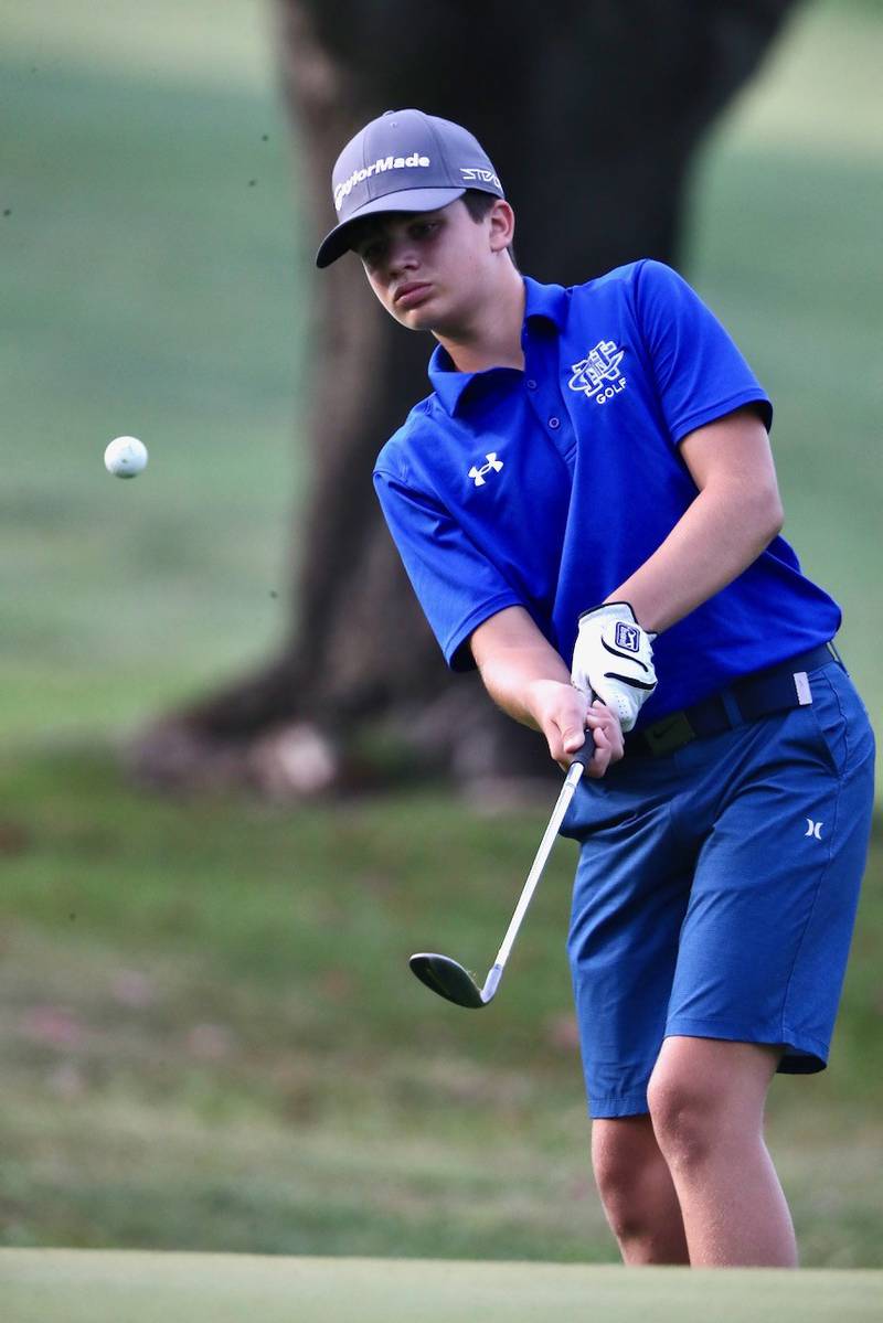 Newman's Michael Morse chips onto the green Monday at Wyaton Hills Golf Course in Princeton.