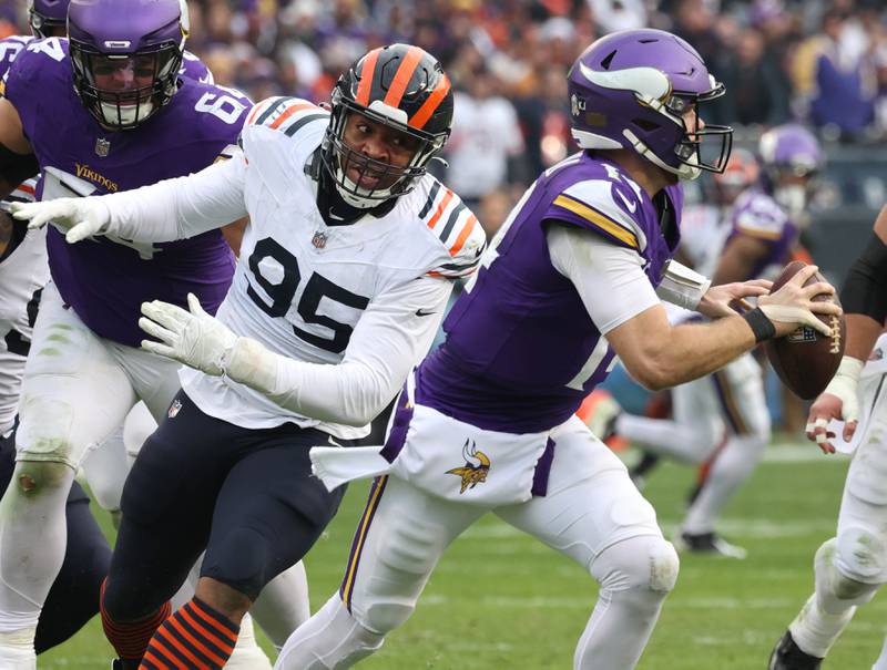 Chicago Bears defensive end DeMarcus Walker pressures Minnesota Vikings quarterback Sam Darnold during their game Sunday, Nov. 24, 2024, at Soldier Field in Chicago.