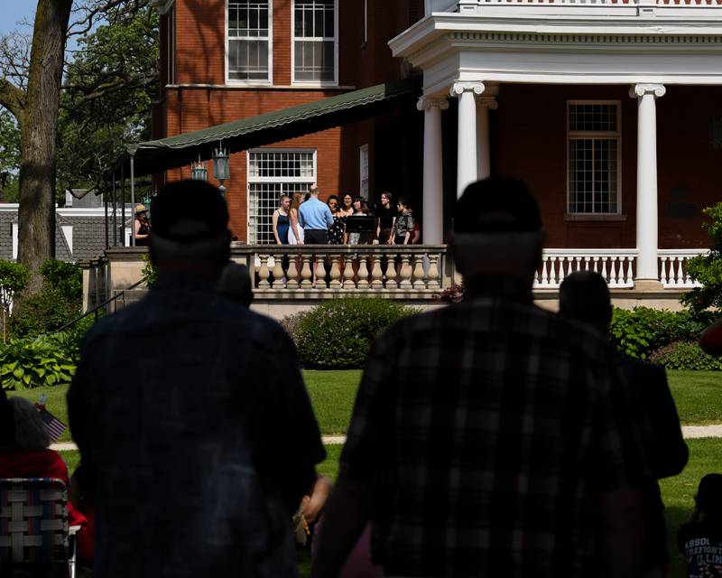 Spectators listen as members of the DeKalb High School Varsity Treble Choir sings during the Memorial Day ceremonies held on the Ellwood house lawn in DeKalb on Monday May 30th.
