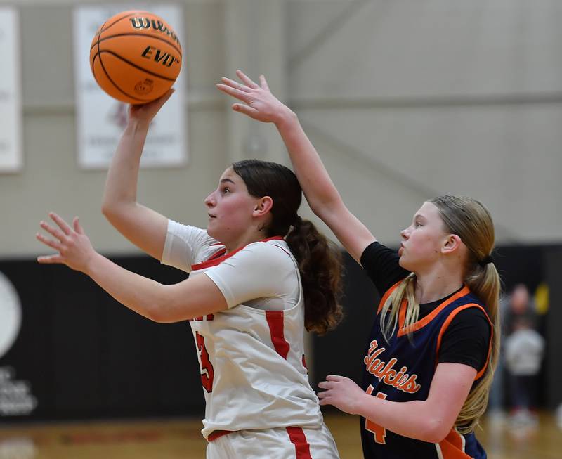 Benet’s Aria Mazza shoots as Naperville North’s Sydney Smith defends during the Class 4A Benet Regional championship game on February 20, 2025 at Benet Academy in Lisle.