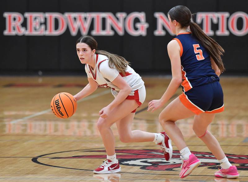 Benet’s Ava Mersinger looks to pass as Naperville North’s Ava Podkasik (5) defends during the Class 4A Benet Regional championship game on February 20, 2025 at Benet Academy in Lisle.