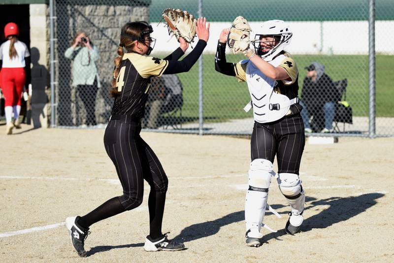 Bishop McNamara's Bridget Bertrand, right, celebrates with pitcher Joslynn Dole during Dole's shutout performance during a 15-0 victory Tuesday, April 8 at Bishop McNamara.