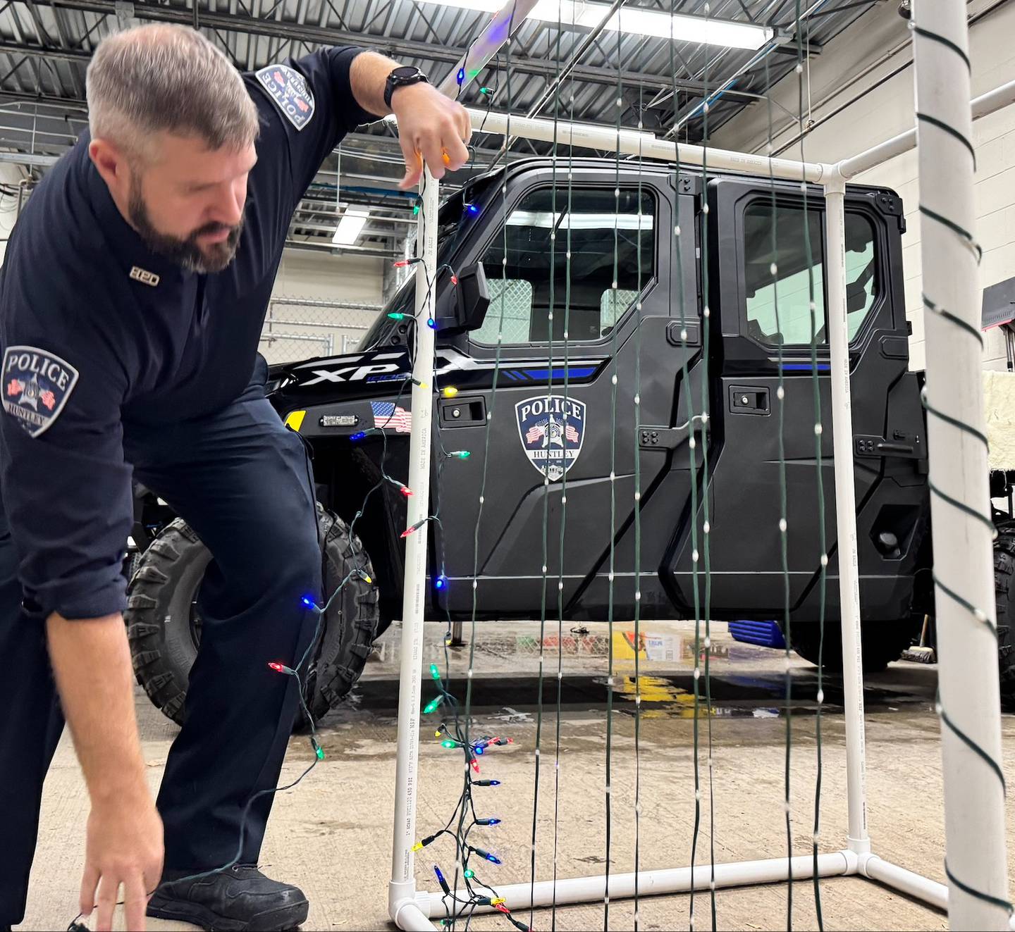 Officer Jerry Keppler from the Huntley Police Department decorates department vehicles Wednesday, Dec. 3, 2025, for Saturday's Christmas parade, a newly added part of the Very Merry Huntley holiday celebration. The parade steps off at 5 p.m. Saturday at the intersection of Main and Bakley streets.