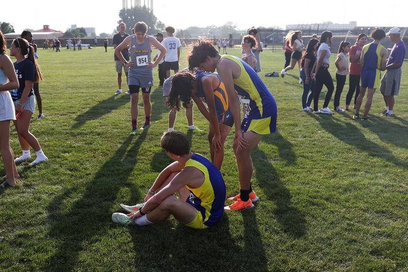 Joliet Central runners catch their breath at the finish line in the Joliet West Cross Country Dual Meet on Monday, Aug. 28, 2023 in Joliet.