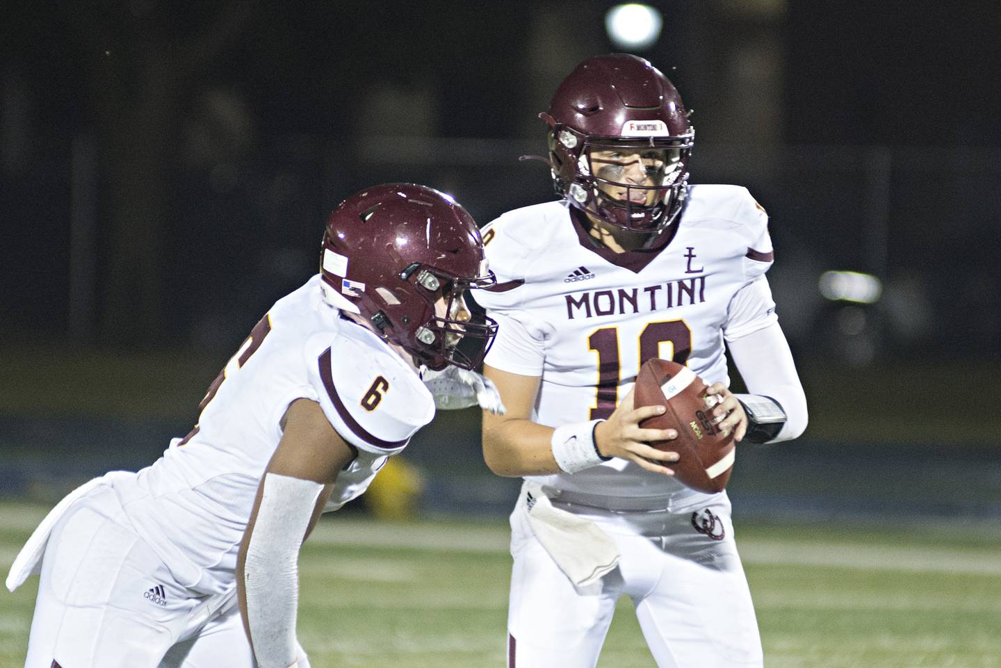 Montini quarterback Cole Teschner hands off to Josh Robinson Friday, September 3, 2021 against Sterling.