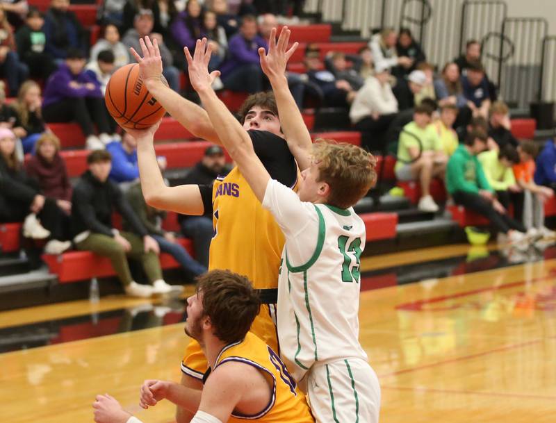 Mendota's Cameron Kelly eyes the basket while teammate Braiden Freeman boxes out Rock Falls's Aydan Goff during the 49th annual Colmone Classic on Friday, Dec. 8, 2023 at Hall High School.